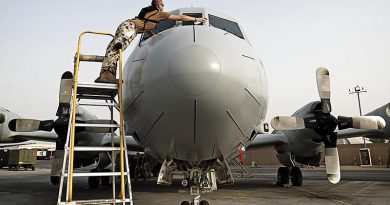 Leading Aircraftman Nick Atterton cleans the windows on an AP-3C Orion in the Middle East. Photo by Able Seaman Paul Berry.