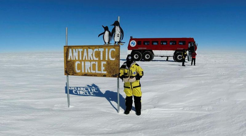 Sergeant Michelle Espley from No. 23 Squadron at the Antarctic Circle sign during Operation Southern Discovery.