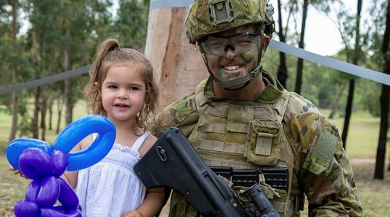 Private Jordan Enright, of the School of Infantry, enjoys the Singleton Military Area family day with his daughter. Photos by Corporal Shane Kelly.