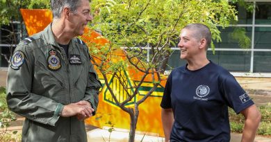 Senior Australian Defence Force Officer - Edinburgh precinct Air Commodore Ross Bender with Flight Lieutenant Lauren Hartley after she had her head shaved to raise money for the Lung Foundation Australia. Photo by Corporal Brenton Kwaterski.