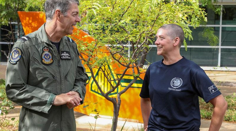 Senior Australian Defence Force Officer - Edinburgh precinct Air Commodore Ross Bender with Flight Lieutenant Lauren Hartley after she had her head shaved to raise money for the Lung Foundation Australia. Photo by Corporal Brenton Kwaterski.