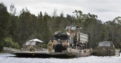 Students from the Bridge Erection Propulsion Boat course manoeuvre a bridge transporting a HX77 truck on the Georges River, Sydney. Photo by Petty Officer Lee-Anne Cooper.