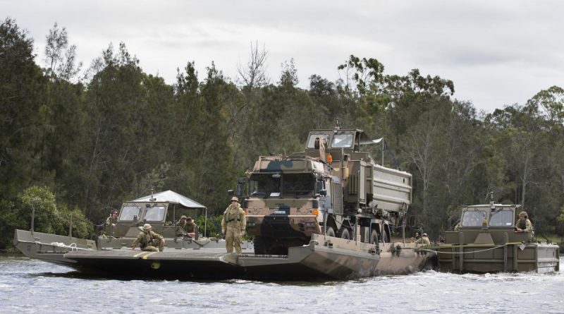 Students from the Bridge Erection Propulsion Boat course manoeuvre a bridge transporting a HX77 truck on the Georges River, Sydney. Photo by Petty Officer Lee-Anne Cooper.