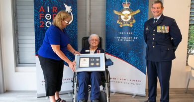 Wilma Ayles, centre, supported by her daughter Evelyn Schuetze, receives an Air Force 2021 memento from Senior ADF Officer Amberley Group Captain Iain Carty at Cooroy, Queensland. Photo by Leading Aircraftwoman Emma Schwenke.