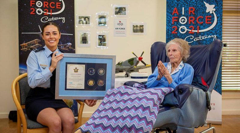 Leading Aircraftwoman Emma Singleton with the Chief of Air Force award presented to her great-grandmother Betty Howells to mark her 100th birthday. Photo by Sergeant Bill Solomou.
