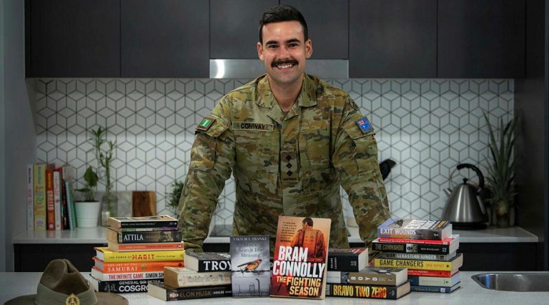 Captain Dylan Conway, of the 6th Battalion, Royal Australian Regiment, with books he read while bed-ridden after surgery. He later recommended books to others as part of his initiative, Brothers n' Books. Photo by Private Jacob Hilton.