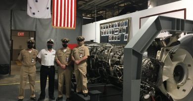 Chief Petty Officer John Bywater, second from left, with South East Regional Maintenance Centre service personnel alongside the gas turbine shop trainer engine at the Naval Station in Mayport, Florida.