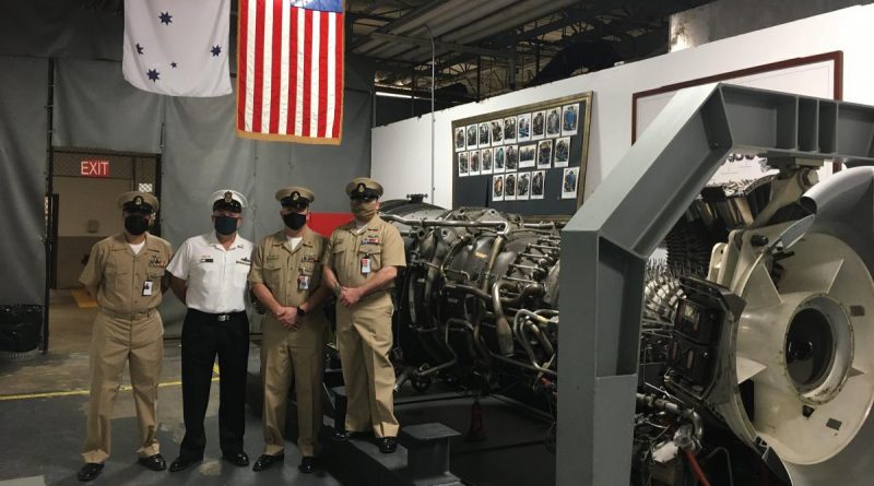 Chief Petty Officer John Bywater, second from left, with South East Regional Maintenance Centre service personnel alongside the gas turbine shop trainer engine at the Naval Station in Mayport, Florida.
