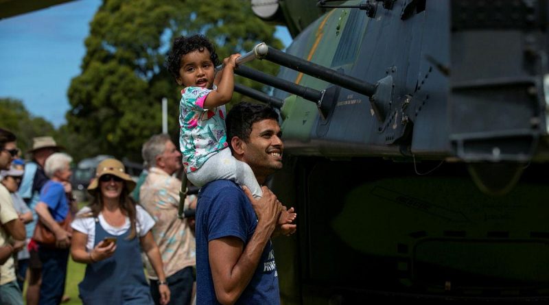 Local residents take a tour of Navy MRH-90 Taipan during HMAS Choules visit to ceremonial homeport of Mallacoota. Photo by Leading Seaman Leo Baumgartner.