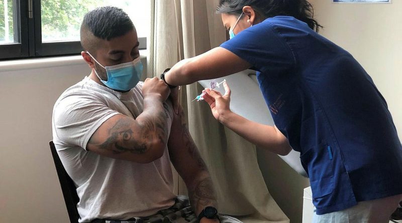 ADF medic Private Christie Rayner, from the Joint Health Unit - North Queensland, administers the COVID-19 vaccine to Lorna Pollack at the Blue Care aged-care facility in Ingham, Queensland.