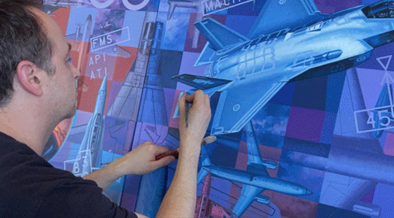 Australian aviation artist Drew Harrison puts finishing touches on the artwork he was commissioned to paint to mark the Centenary of the Royal Australian Air Force. Image supplied.