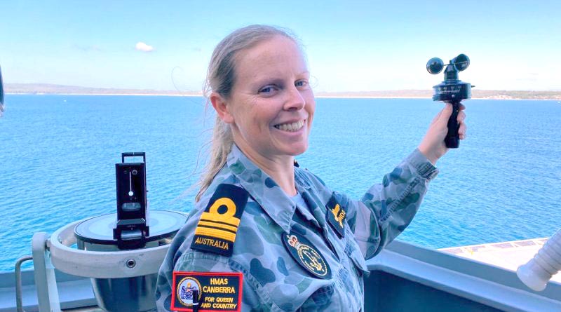 Meteorologist and oceanographer Lieutenant Commander Fiona Simmonds uses an anemometer to measure wind speed aboard HMAS Canberra in Jervis Bay.