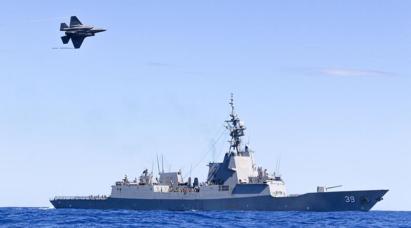 A Royal Australian Air Force F-35A Lightning conducts a flypast over HMAS Hobart during Exercise Tasman Shield 21 off the east coast of Australia. Photo by Petty officer Brendan Matchett.