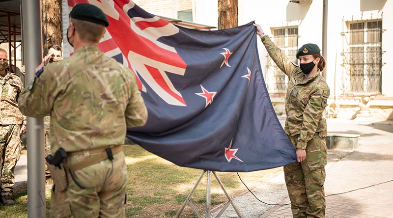 New Zealand Defence Force personnel lower the New Zealand National Flag in Kabul for the last time. NZDF photo.