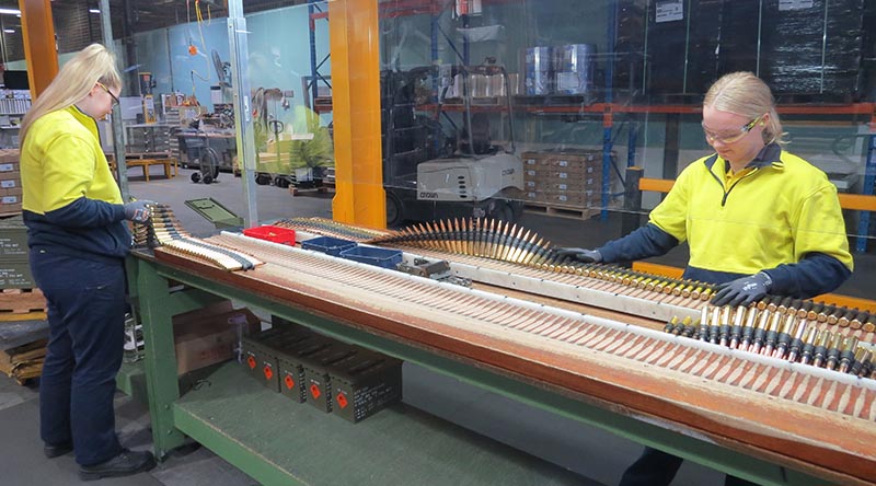 Thales Australia employees conduct final visual inspection on .50 calibre link ammunition at Benalla, Victoria. Thales photo.