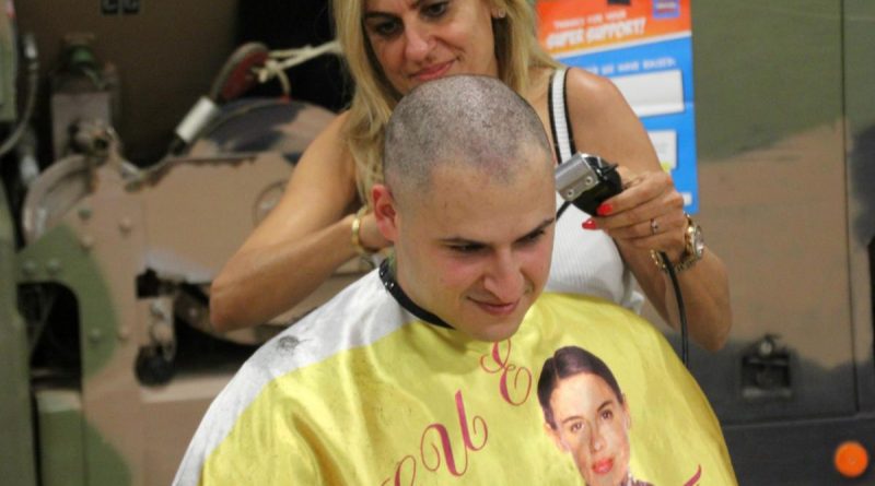Trooper Darius Kaveh-Ahangari has his head shaved as part of Shave for a Cure.