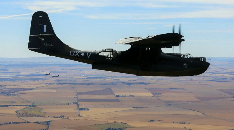 A24-362 OX-V Catalina takes to the skies near RAAF Base Edinburgh. In the background a Neptune and a AP-3C Orion. 3 generations of 11 Squadron aircraft. Photo by Corporal Craig Barrett.