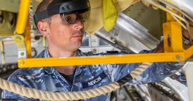 Avionics Technician, Corporal Joshua Newbon from No. 36 Squadron, utilises the Hololens mixed reality device during maintenance of a C-17A Globemaster III aircraft. Story by Samara Kitchener. RAAF file photo.
