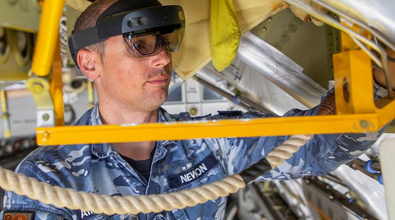 Avionics Technician, Corporal Joshua Newbon from No. 36 Squadron, utilises the Hololens mixed reality device during maintenance of a C-17A Globemaster III aircraft. Story by Samara Kitchener. RAAF file photo.