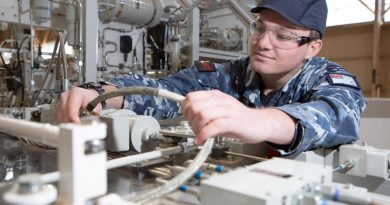 Aircraftman Bailey Gray sporting a bump cap while undertaking maintenance checks on the GENFLY 1 training aid at the RAAF School of Technical Training, RAAF Base Wagga. Story by Flight Lieutenant Julia Ravell. Photo by Corporal Kylie Gibson.