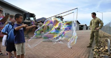 Children of soldiers of the 1st Combat Engineer Regiment make bubbles during the regiment's family day.