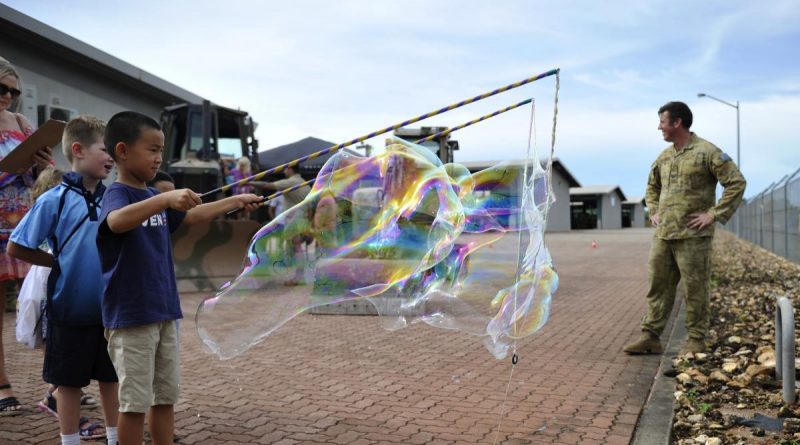 Children of soldiers of the 1st Combat Engineer Regiment make bubbles during the regiment's family day.