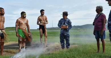 Les Tanna, left, Ashley Saltner, Glen Thomas, Flight Lieutenant David Williams holding soil from Wulgurukaba land, Virginia Wyles and Wing Commander Mathew Green at RAAF Base Townsville. Photo by Corporal Luke Garner.