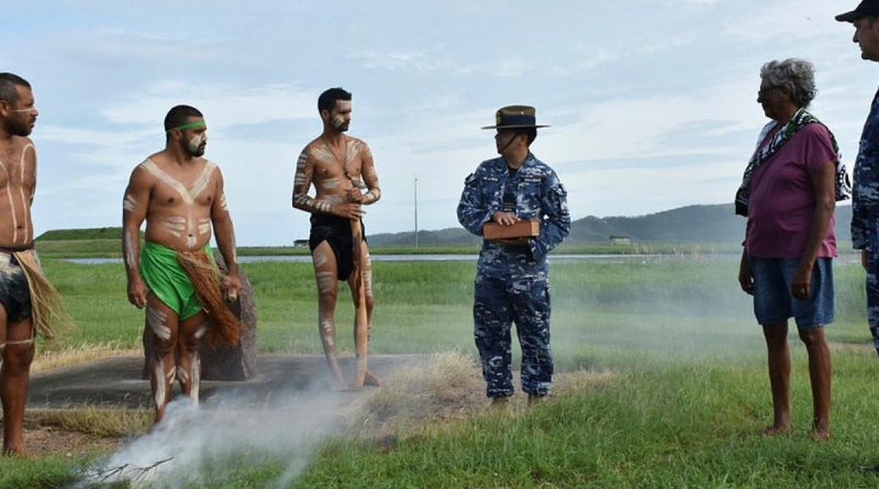 Les Tanna, left, Ashley Saltner, Glen Thomas, Flight Lieutenant David Williams holding soil from Wulgurukaba land, Virginia Wyles and Wing Commander Mathew Green at RAAF Base Townsville. Photo by Corporal Luke Garner.