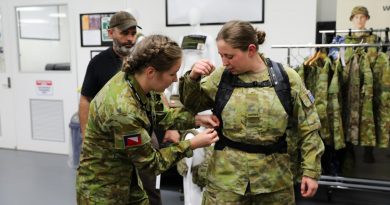 Lance Corporal Rebecca Baxter from the 4th/19th Prince of Wales Light Horse Regiment adjusts the prototype female heavy-webbing harness and belt on Private Jessica Russell from the 8th/7th Battalion, Royal Victoria Regiment. Photo by Captain Kristen Cleland.