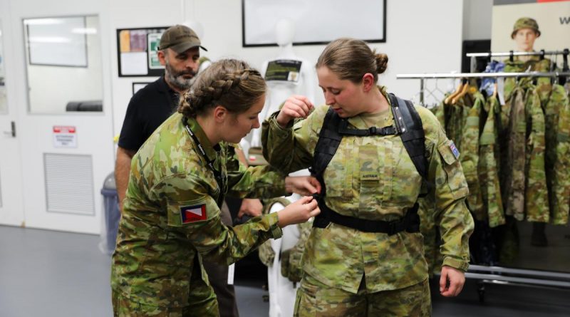 Lance Corporal Rebecca Baxter from the 4th/19th Prince of Wales Light Horse Regiment adjusts the prototype female heavy-webbing harness and belt on Private Jessica Russell from the 8th/7th Battalion, Royal Victoria Regiment. Photo by Captain Kristen Cleland.