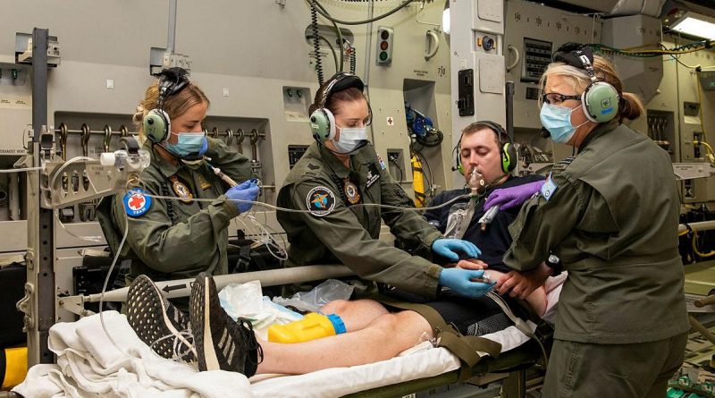 Corporal Kate Fox, left, Sergeant Fiona Jackson and Flight Lieutenant Susan Coretti treat a simulated patient during an Aeromedical Evacuation Training Exercise on board a C-17 Globemaster III. Photo by Leading Aircraftwoman Emma Schwenke.