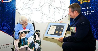 Senior Australian Defence Force Officer RAAF Base Amberley Group Captain Iain Carty presents Air Force veteran Mary Collins with an Air Force 2021 commemorative memento in celebration of her 100th birthday. Photo by Corporal Brett Sherriff.