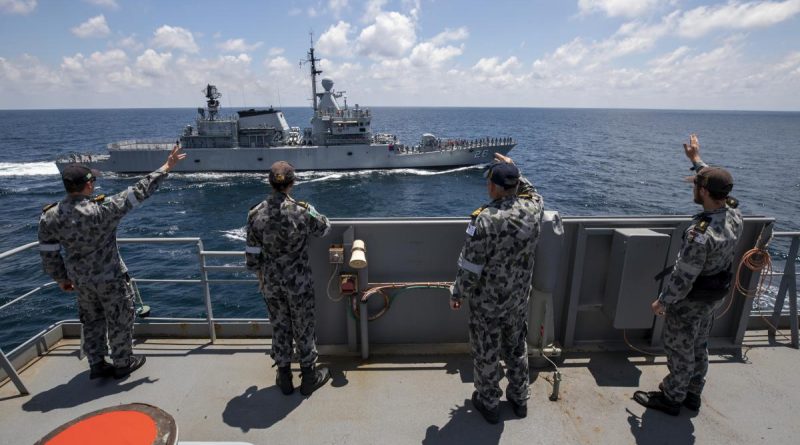 Members of HMAS Sirius’ ship's company wave to the crew of Royal Malaysian Navy ship KD Lekir in the Andaman Sea. Photo by Leading Seaman Thomas Sawtell.