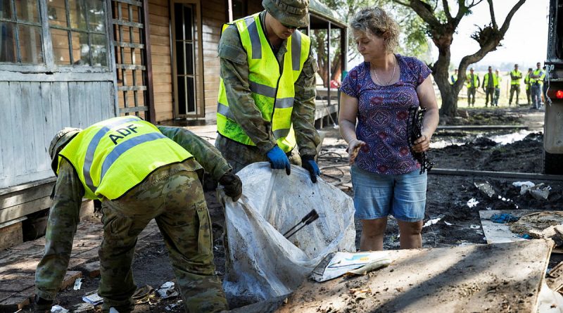 Soldiers remove debris from a flood-damaged property in Taree. Photo by Corporal Sagi Biderman .