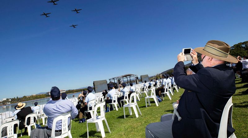 Royal Australian Air Force veteran Mr Alan Sullivan takes photos of Royal Australian Air Force aircraft flying over Rond Terrace, Canberra during the Air Force 2021 Centenary flyover. Photo by Cpl David Said.