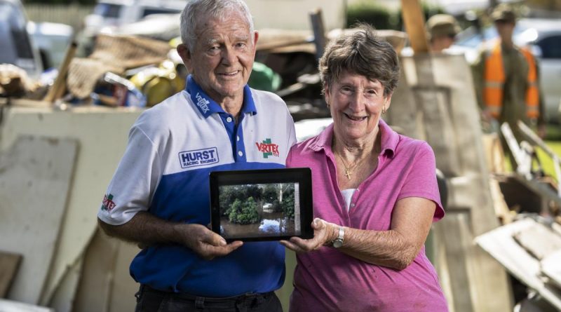 Alan and Janice Hunt stand in front of flood damaged possessions in Lower MacDonald, NSW. Photo by Corporal Sagi Biderman.