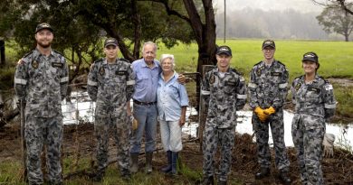 Sailors with Neil and Gwen Mcleod after clearing debris from their flood-damaged property in Scotts Head, NSW. Photo by Corporal Robert Whitmore.