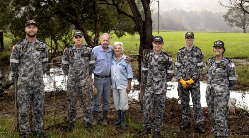 Sailors with Neil and Gwen Mcleod after clearing debris from their flood-damaged property in Scotts Head, NSW. Photo by Corporal Robert Whitmore.