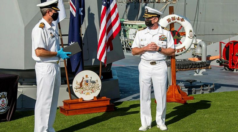 Commanding Officer HMAS Sydney Commander Ted Seymour, left, presents United States Navy officer Commander Robert Eilers with a Commander Australian Fleet Silver Commendation on board Sydney in San Diego. Story by Lieutenant Commander Scott MacPherson.