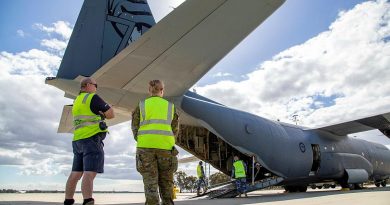 Sergeant John Braken (left) and Corporal Amber Nichols observe the loading of a C-130J Hercules at RAAF Base Pearce as part of Defence's support to the WA Government following Tropical Cyclone. Photo by Petty Officer Yuri Ramsey.