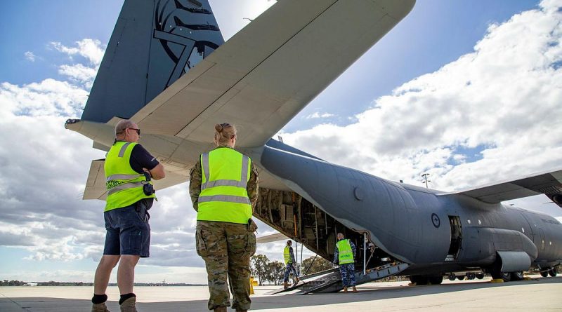 Sergeant John Braken (left) and Corporal Amber Nichols observe the loading of a C-130J Hercules at RAAF Base Pearce as part of Defence's support to the WA Government following Tropical Cyclone. Photo by Petty Officer Yuri Ramsey.