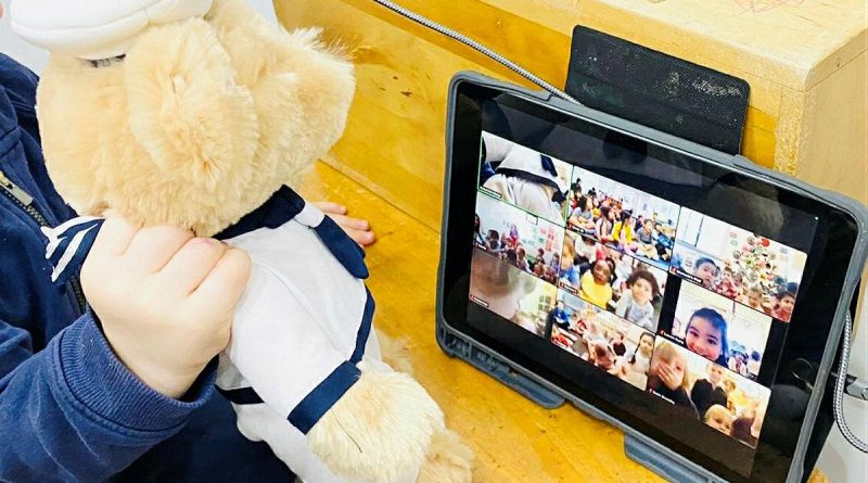 CAPTION: A Navy teddy is held by a child from the Vaucluse Cottage Childcare Centre in Sydney, during a Zoom call to sister preschools. Story by Lieutenant Kiz Welling-Burtenshaw. Photo by Emma Wholihan.