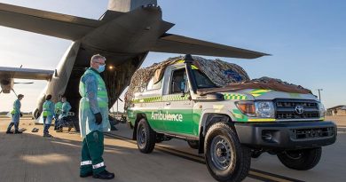 Andrew Thomas, Director of Ambulances, St John Ambulance Northern Territory, speaks with Royal Australian Air Force Corporal Rebecca Love before she loads a St John PNG ambulance onto a RAAF C-130J Hercules headed to Port Moresby, Papua New Guinea from RAAF Darwin, Northern Territory. Photo by Corporal Rodrigo Villablanca.