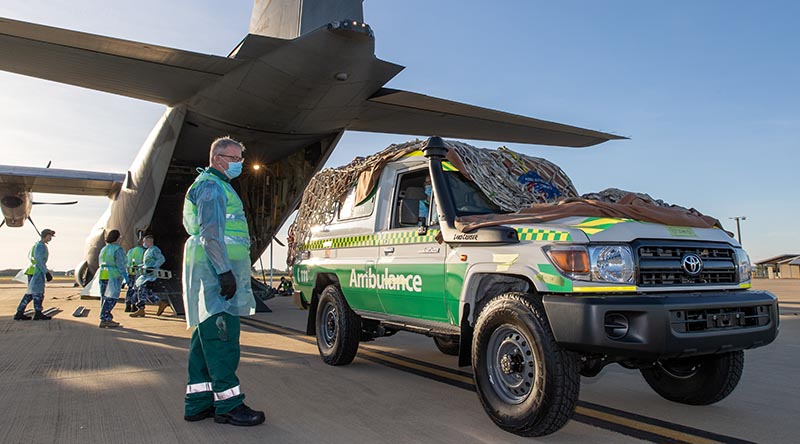 Andrew Thomas, Director of Ambulances, St John Ambulance Northern Territory, speaks with Royal Australian Air Force Corporal Rebecca Love before she loads a St John PNG ambulance onto a RAAF C-130J Hercules headed to Port Moresby, Papua New Guinea from RAAF Darwin, Northern Territory. Photo by Corporal Rodrigo Villablanca.