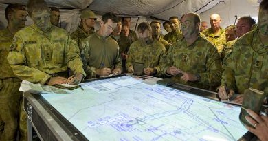 Commander 3rd Brigadier Roger Noble briefs subordinates before a brigade live-fire activity using a networked electronic battle management system display. Photo by Corporal David Cotton.