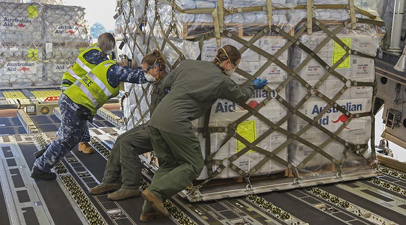 Royal Australian Air Force Air Movements Operators from No. 23 Squadron and No. 36 Squadron loadmasters, load a pallet of humanitarian aid on board a 36SQN C-17A Globemaster. Photo by Corporal Jesse Kane.