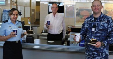 Veteran Paul Beraldo with Squadron Leaders Robyn Connell and Dane Johnson inside the Army and Air Force Canteen Service at RAAF Laverton.