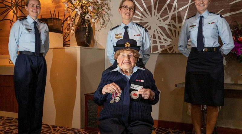 Leading Aircraftwoman Carley Dunn, left, Squadron Leader Del Gaudry, and Corporal Maddison Henry stand with Mrs Iris Terry during a formal presentation of a uniform at the Fairfield RSL. Story by Eamon Hamilton. Photo by Corporal Kylie Gibson.