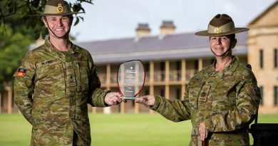 Commander Forces Command Major General Matthew Pearse and Command Sergeant Major Warrant Officer Class One Kim Felmingham hold the trophy on behalf of Army at Victoria Barracks, Sydney. Story by Private Jacob Joseph. Photo by Sergeant Nunu Campos.