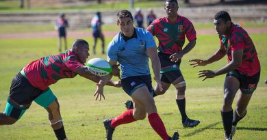 A player from the Republic of Fiji Military Forces team, left, attempts to intercept Craftsman Shaun Coel during the Malo-Bula Cup at Gallipoli Barracks. Story by Captain Jesse Robilliard. Photo by Private Hamid Farahani.